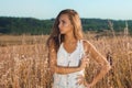 Sensual young girl standing posing in the field of tall grass Royalty Free Stock Photo