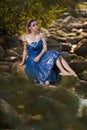 Sensual Young Mermaid of Sea in Artistic Caucasian Blond Woman With Strasses on Face Sitting in Blue Wet Dress on Rocky Shore Royalty Free Stock Photo