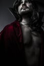 Sensual Young Vampire with black coat and long hair, nude Royalty Free Stock Photo