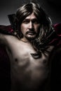 Sensual Young Vampire with black coat and long hair, nude Royalty Free Stock Photo