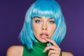 Sensual young woman in blue wig touching lip, isolated Royalty Free Stock Photo