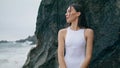 Sensual woman looking seascape leaning on rock close up. Girl standing on beach. Royalty Free Stock Photo