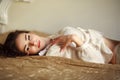 Sensual young woman thoughtfully lying on the bed at home Royalty Free Stock Photo