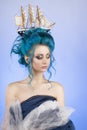 Sensual young girl with naked shoulders and painted blue hair st