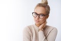 Sensuality, beauty and lifestyle concept. Attractive blond woman in glasses combed hair touching neck and tilting head Royalty Free Stock Photo