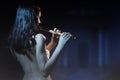 Sensuality brunette plays a wooden flute