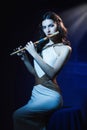 Sensuality brunette plays a wooden flute