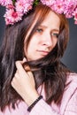 Sensuality girl nymph with floral wreath from pink chrysanthemums on her head