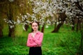 Sensuality. Happy beautiful young woman relaxing in blossom park