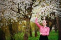 Sensuality. Happy beautiful young woman relaxing in blossom park