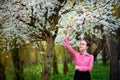 Sensuality. Happy beautiful young woman relaxing in blossom park