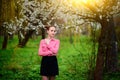 Sensuality. Happy beautiful young woman relaxing in blossom park