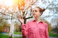 Sensuality. Happy beautiful young woman relaxing in blossom park