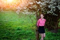 Sensuality. Happy beautiful young woman relaxing in blossom park