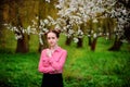 Sensuality. Happy beautiful young woman relaxing in blossom park