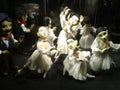 Sensually dancing ballerina puppets in white dresses on strings in dramatic light at the Augsburger Puppenkiste