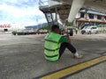 Sentani, Jayapura, Indonesia - March 17, 2023 : a porter sit under airplane and standby for late baggages