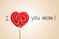 The sentence I love you mom with a heart-shaped lollipop