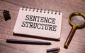 SENTENCE STRUCTURE - words in a white notepad on the background of a laptop with pencils.