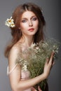 Sentiment. Portrait of Redhair Nostalgic Woman with Herbs