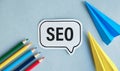 Opened Notebook With Seo-Optimization Scheme Lying Over blue Office Table Background. Search Engine Optimization For