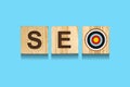 SEO concept. Search engine optimization. Word on wooden blocks isolated on light blue background Royalty Free Stock Photo