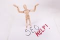 SEO help overwhelmed wooden jointed manikin doll holding up hands