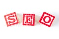 SEO Search Engine Optimization - Alphabet Baby Blocks on white Royalty Free Stock Photo