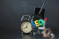 SEO Search engine optimization concept Colored letters of SEO with clock, magnifying , smartphone, gears in a basket on a black ba Royalty Free Stock Photo