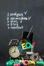 SEO Search engine optimization concept Colored letters of SEO with clock, magnifying , smartphone, gears in a basket on a black ba Royalty Free Stock Photo