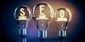 SEO, search engine optimization concept - shining light bulbs Royalty Free Stock Photo