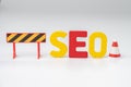 SEO, Search Engine Optimization ranking concept, alphabets abbreviation SEO with traffic cone for under construction on white Royalty Free Stock Photo