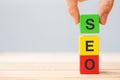 SEO Search Engine Optimization text wooden cube blocks on table background. Idea, Strategy, marketing, Keyword and Content Royalty Free Stock Photo
