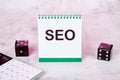 Seo text on a notepad standing on the table is an open Notebook With An Seo Optimization Scheme. Search Engine Optimization Of Web Royalty Free Stock Photo