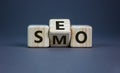 SEO vs SMO. Turned a cube and changed the word `SMO - social media optimization` to `SEO - search engine optimization`. Busine Royalty Free Stock Photo