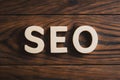 SEO word on wooden floor, search engine optimization concept