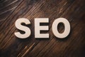 SEO word on wooden floor, search engine optimization concept