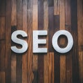 SEO word on wooden floor, search engine optimization concept