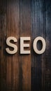 SEO word on wooden floor, search engine optimization concept