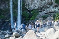 Tourists making pictures at the Jeongbang waterfall in Seogwipo, Jeju Island, South Korea Royalty Free Stock Photo