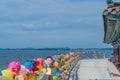 Paper lanterns tied to railing at seaside templ