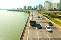 SEOUL, KOREA - AUGUST 14, 2015: Cars passing highway road along Han river with business and residential area near by - Seoul, Sout