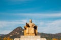 The statue of King Sejong with autumn mountain at Gwanghwamun square in Seoul, Korea