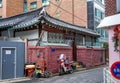 Ancient hanok house, bike and motorcycle at the fence.