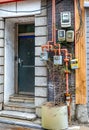 Individual gas and electric meters on the wall of a residential building