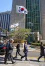 The national flag of the Republic of Korea. Office high-rise buildings. Office workers go to work Royalty Free Stock Photo