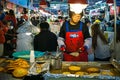 Woman vendor frying a Bindae-tteok, or mung bean pancake