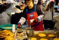 Woman Frying a Bindae tteok or mung bean cake at Gwangjang Food Market
