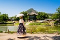 Seoul, South Korea. Hanbok wearing woman. Gyeongbokgung palace park garden. Korean dress tradition. Hyangwonjeong Pavilion. Royalty Free Stock Photo