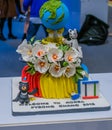 Colorful cake of flowers and olympic mascots make of chocolate